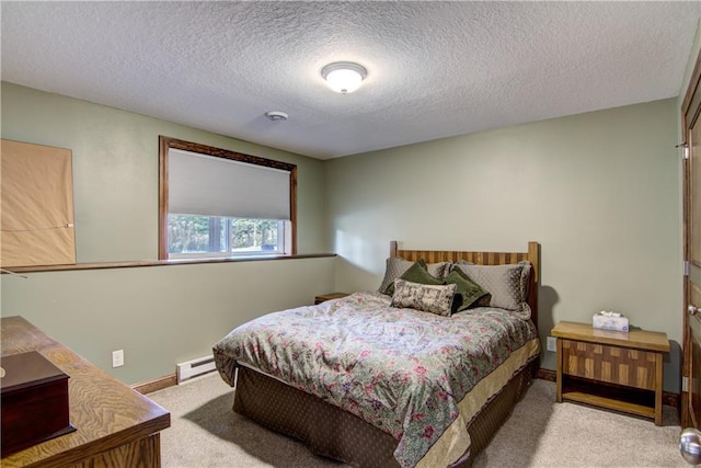 bedroom featuring light carpet, a textured ceiling, and baseboard heating