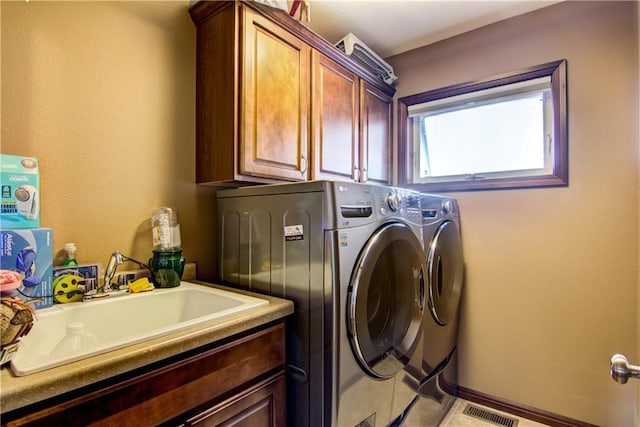 washroom with cabinets, sink, washer and clothes dryer, and light tile patterned floors