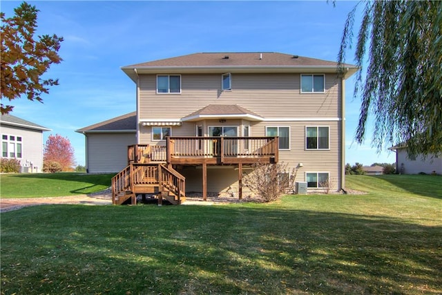 back of house with a deck and a lawn