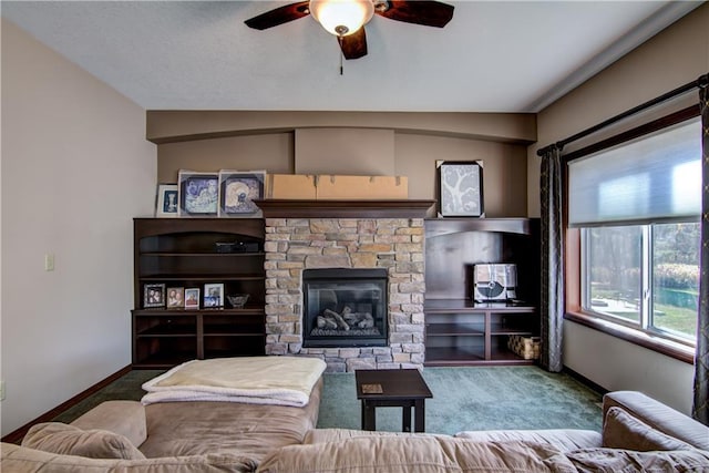 living room featuring a stone fireplace, carpet flooring, and ceiling fan