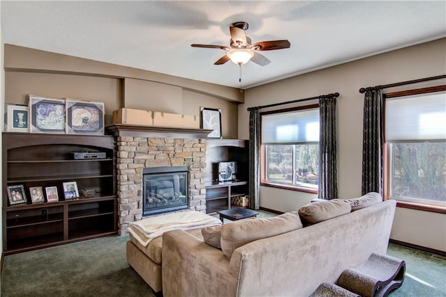 carpeted living room with a fireplace and ceiling fan