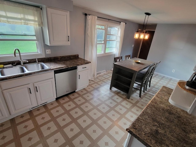 kitchen with white cabinetry, sink, stainless steel dishwasher, and hanging light fixtures