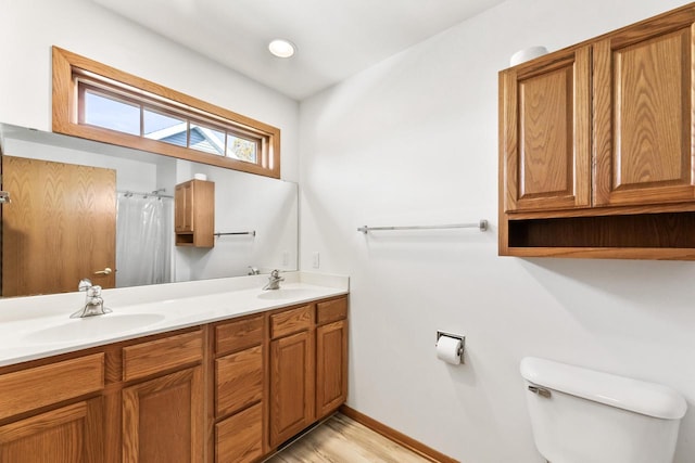 bathroom with vanity, toilet, a shower with shower curtain, and hardwood / wood-style floors