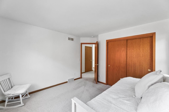 interior space with light carpet and a closet