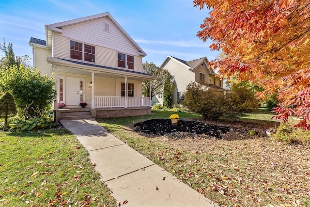 view of front of home featuring a front lawn and a porch