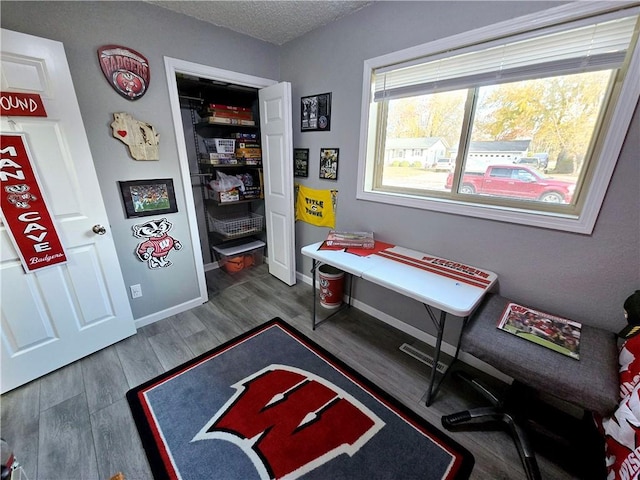 playroom featuring a textured ceiling and hardwood / wood-style flooring