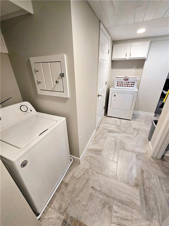 washroom featuring washer / clothes dryer and cabinets