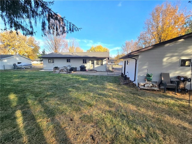 back of property with a patio and a lawn