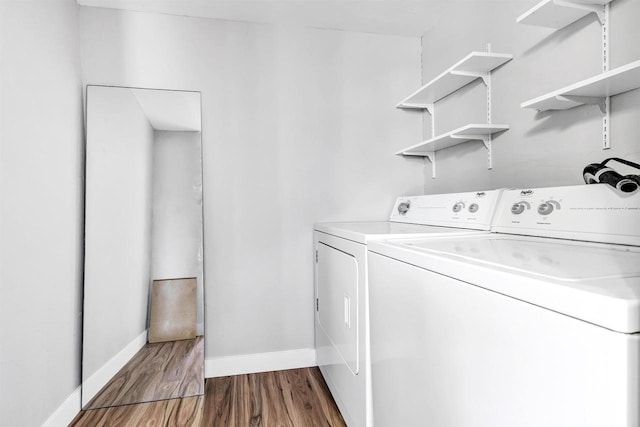 laundry area with washing machine and dryer and hardwood / wood-style floors