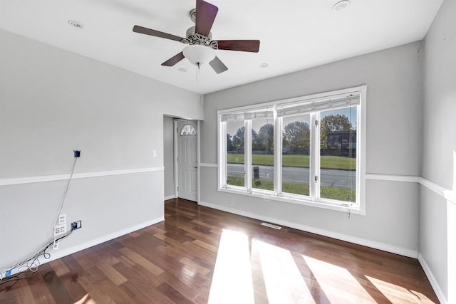 unfurnished room with dark hardwood / wood-style floors and ceiling fan