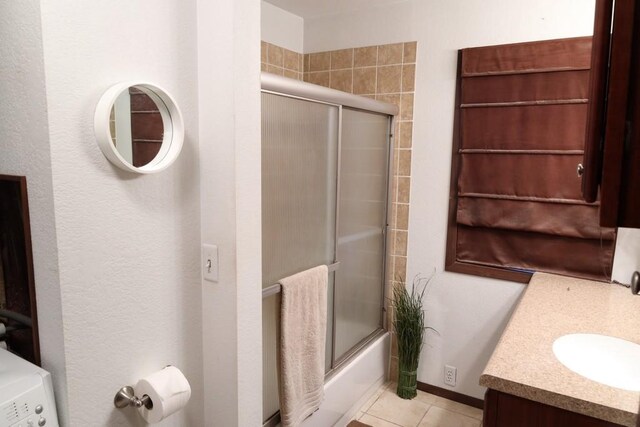 bathroom with vanity, shower / bath combination with glass door, and tile patterned floors