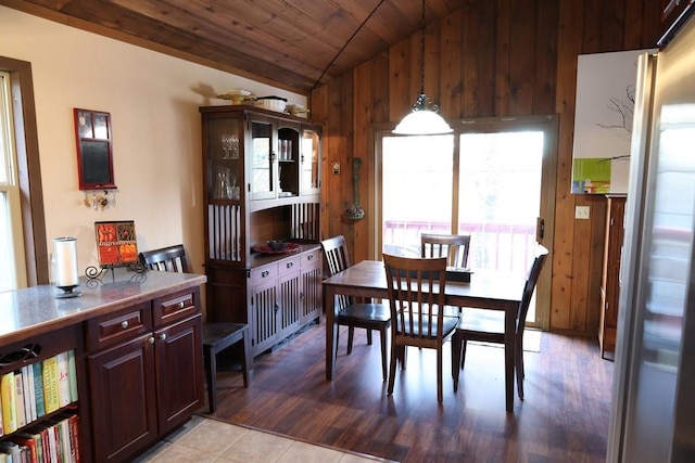 dining room featuring light hardwood / wood-style flooring, wood ceiling, and lofted ceiling