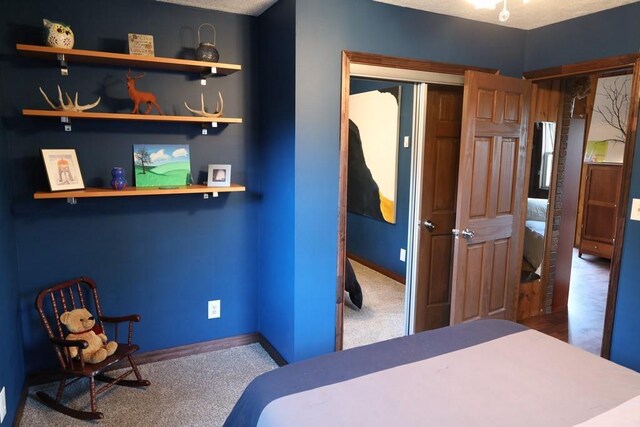 bedroom with a closet, carpet flooring, and a textured ceiling