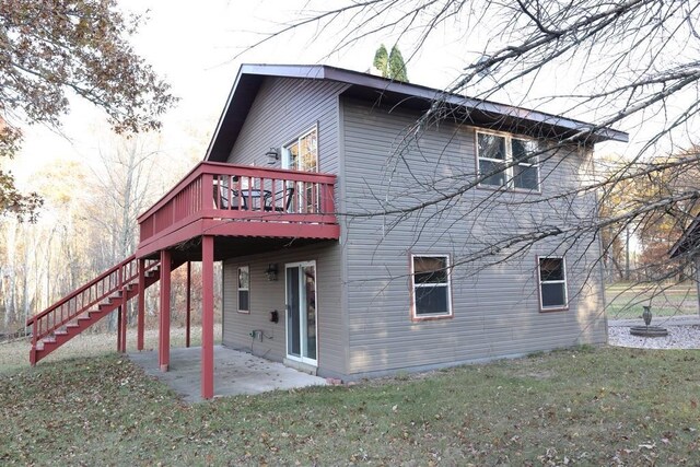 back of house with a patio area, a deck, and a lawn