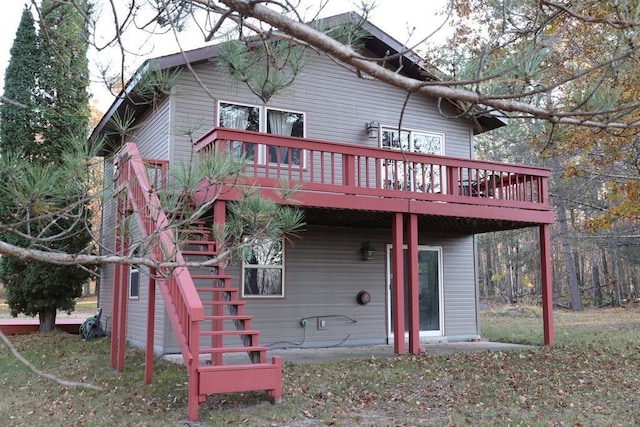 back of house featuring a wooden deck