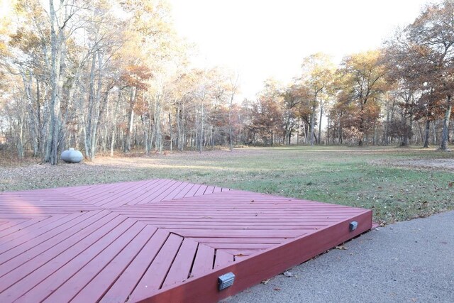 wooden deck featuring a yard