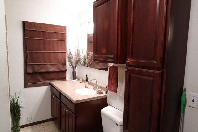 bathroom with vanity, toilet, and tile patterned flooring