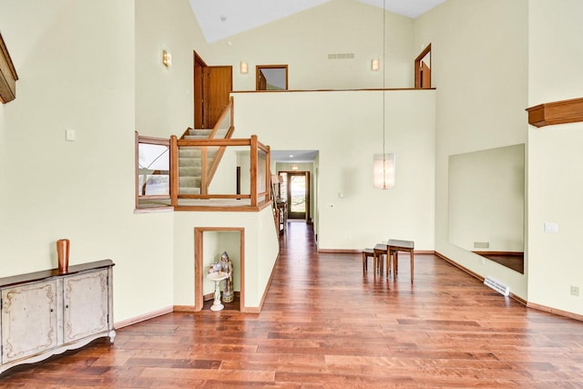 interior space featuring hardwood / wood-style floors and high vaulted ceiling