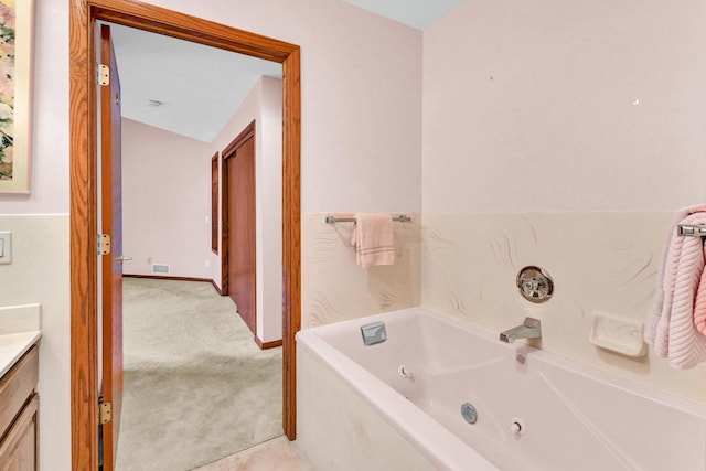 bathroom featuring vanity and a washtub