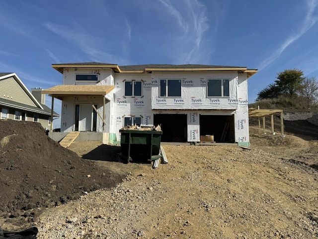 rear view of house featuring a garage