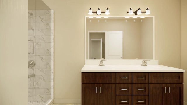 bathroom featuring tiled shower and vanity