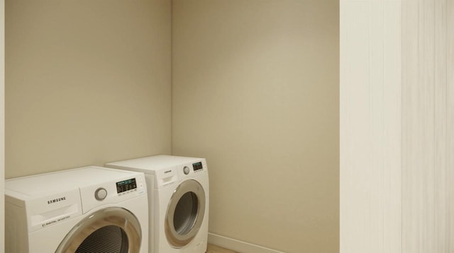 clothes washing area featuring washer and clothes dryer