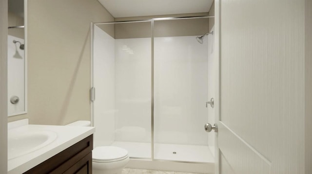 bathroom with toilet, a shower with door, and vanity