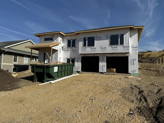 rear view of property featuring a garage