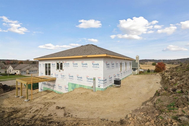 view of side of property featuring central AC