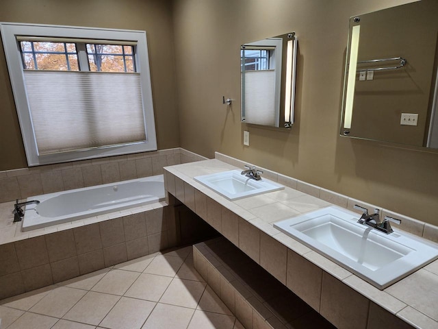 bathroom featuring vanity, tiled tub, and tile patterned flooring