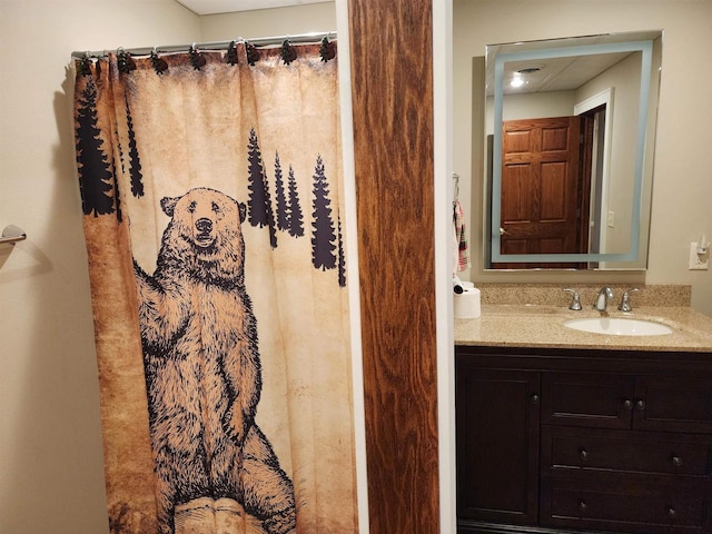 bathroom featuring vanity and a shower with curtain