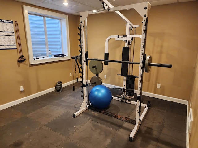 exercise area with a paneled ceiling