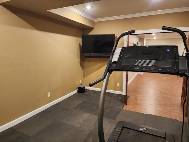 exercise room with crown molding and dark hardwood / wood-style flooring