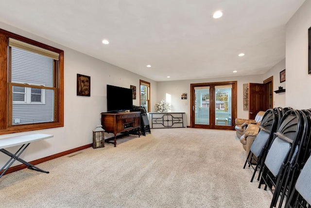 living room featuring french doors and light carpet