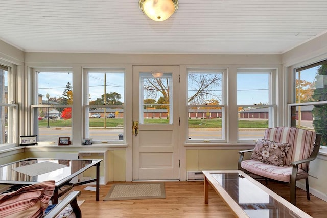 sunroom with a baseboard radiator and a wealth of natural light