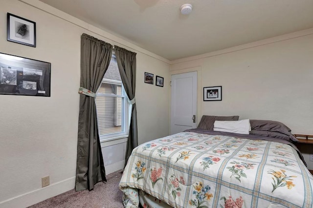 carpeted bedroom featuring crown molding