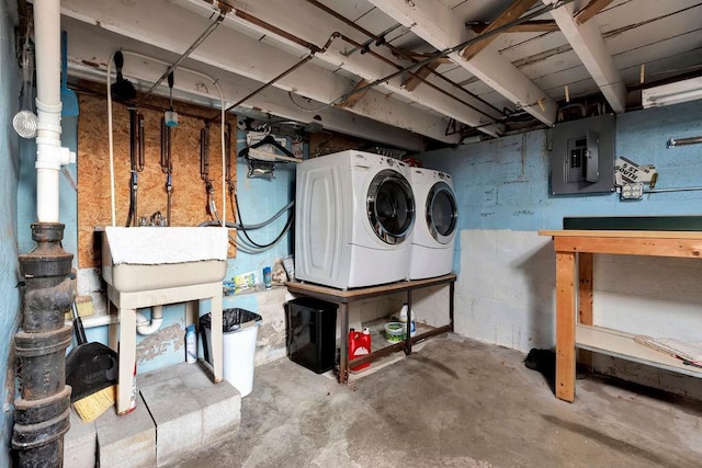 basement with electric panel and washer and clothes dryer