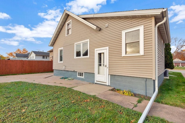 back of house featuring a patio area, central AC, and a lawn