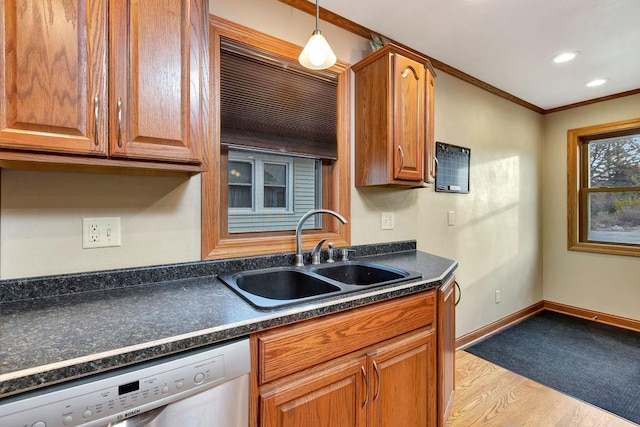 kitchen featuring stainless steel dishwasher, light hardwood / wood-style flooring, sink, crown molding, and decorative light fixtures