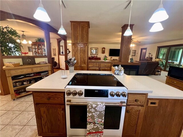 kitchen featuring high end stainless steel range, pendant lighting, light tile patterned floors, and ceiling fan