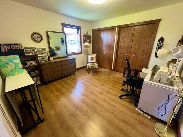 home office with light hardwood / wood-style floors