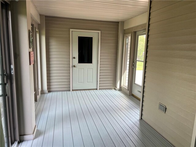 unfurnished sunroom with wooden ceiling