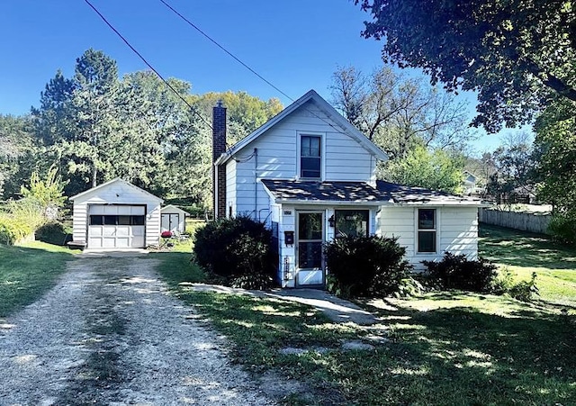 view of front of house with an outdoor structure, a front lawn, and a garage