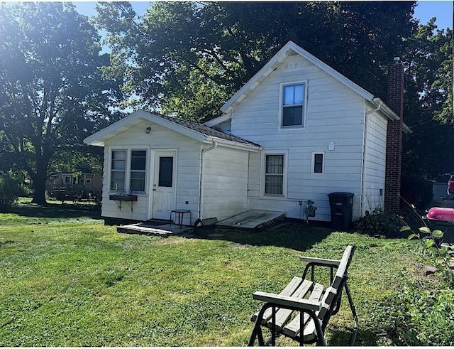 back of house with a yard