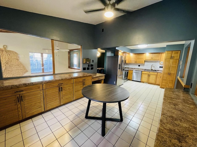 kitchen featuring sink, appliances with stainless steel finishes, ceiling fan, and light tile patterned flooring