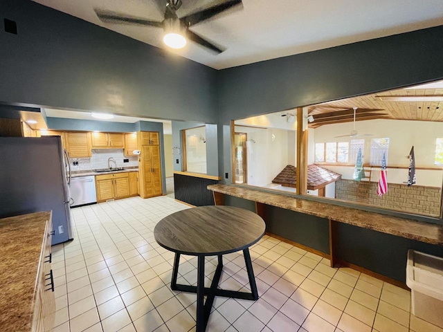 kitchen featuring wood ceiling, stainless steel appliances, decorative backsplash, and vaulted ceiling with beams