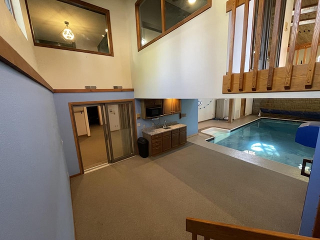 view of swimming pool with sink and a jacuzzi