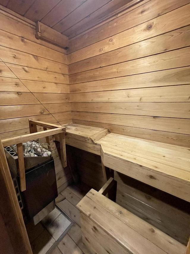 view of sauna with wood walls and wooden ceiling