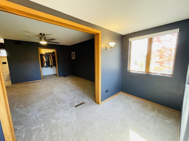 spare room with carpet floors and ceiling fan