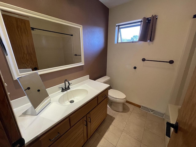 bathroom featuring vanity, a shower, toilet, and tile patterned floors